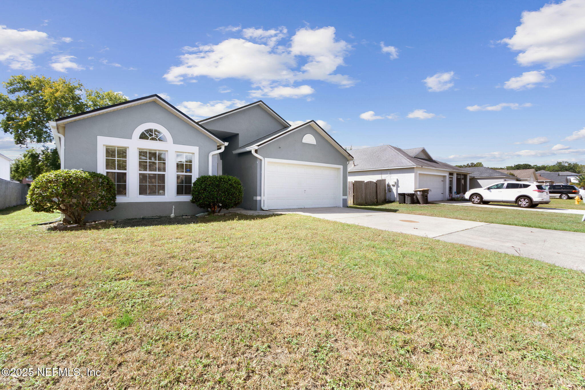 7364 Edenfield Park Road Jacksonville, FL 32244 - Photo 5 of 31 a front view of a house with a yard and garage