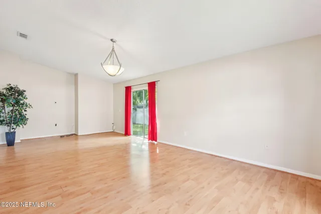 a view of an empty room with windows