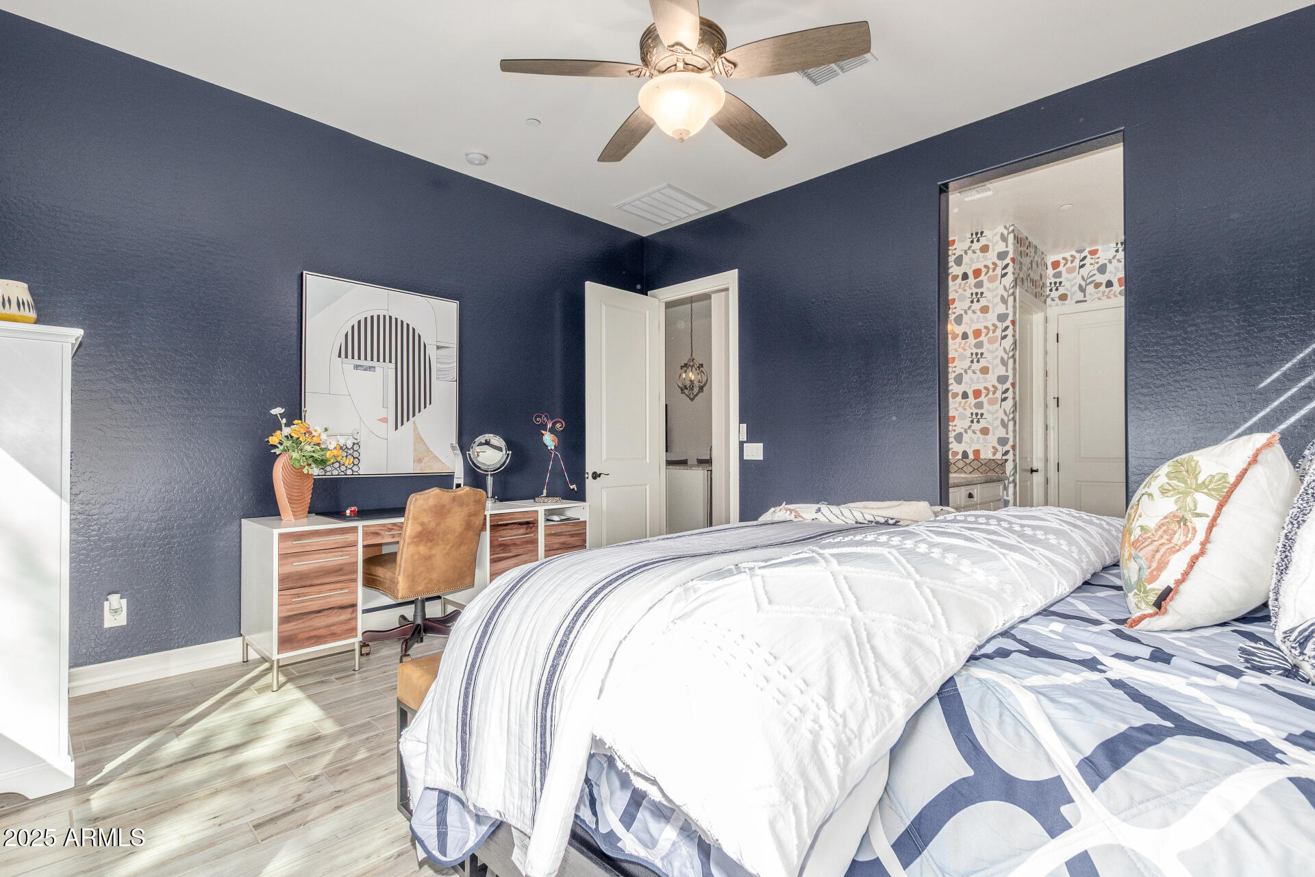 18805 East Blue Sky Drive Rio Verde, AZ 85263 - Photo 15 of 43 a bedroom with a bed and a chandelier