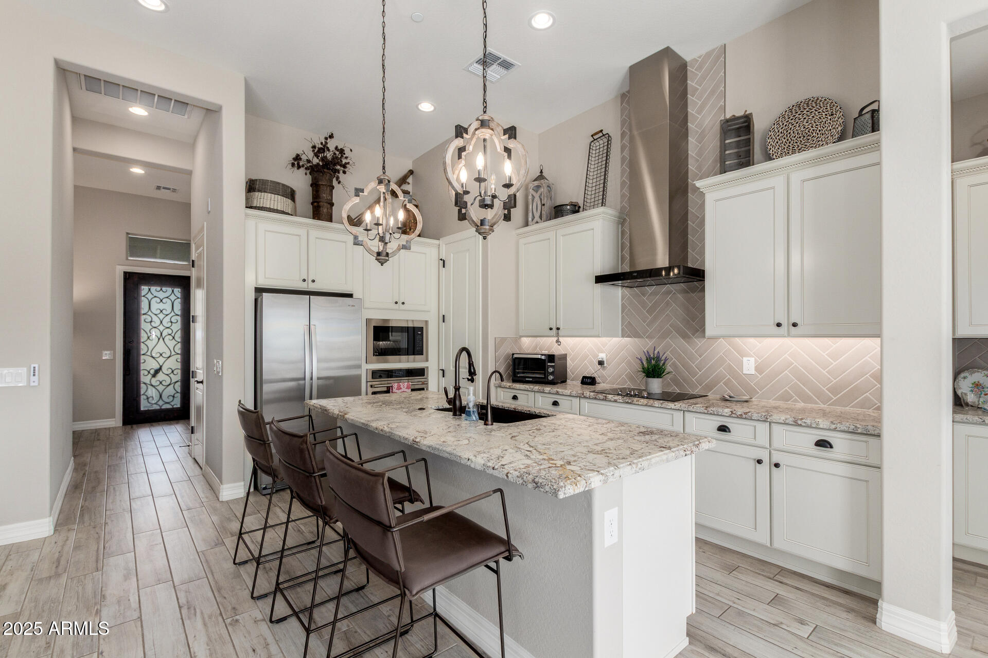 18805 East Blue Sky Drive Rio Verde, AZ 85263 - Photo 10 of 43 a kitchen with kitchen island granite countertop a sink cabinets and refrigerator