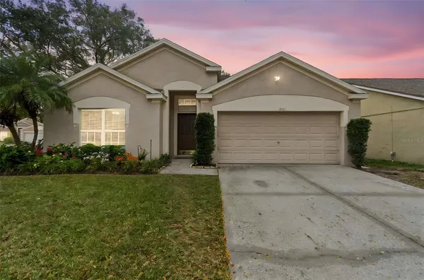 a front view of a house with a yard and garage