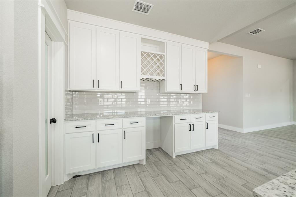 2017 Swallowtail Court Poolville, TX 76487 - Photo 16 of 32 a kitchen with granite countertop white cabinets white appliances with a sink and dishwasher