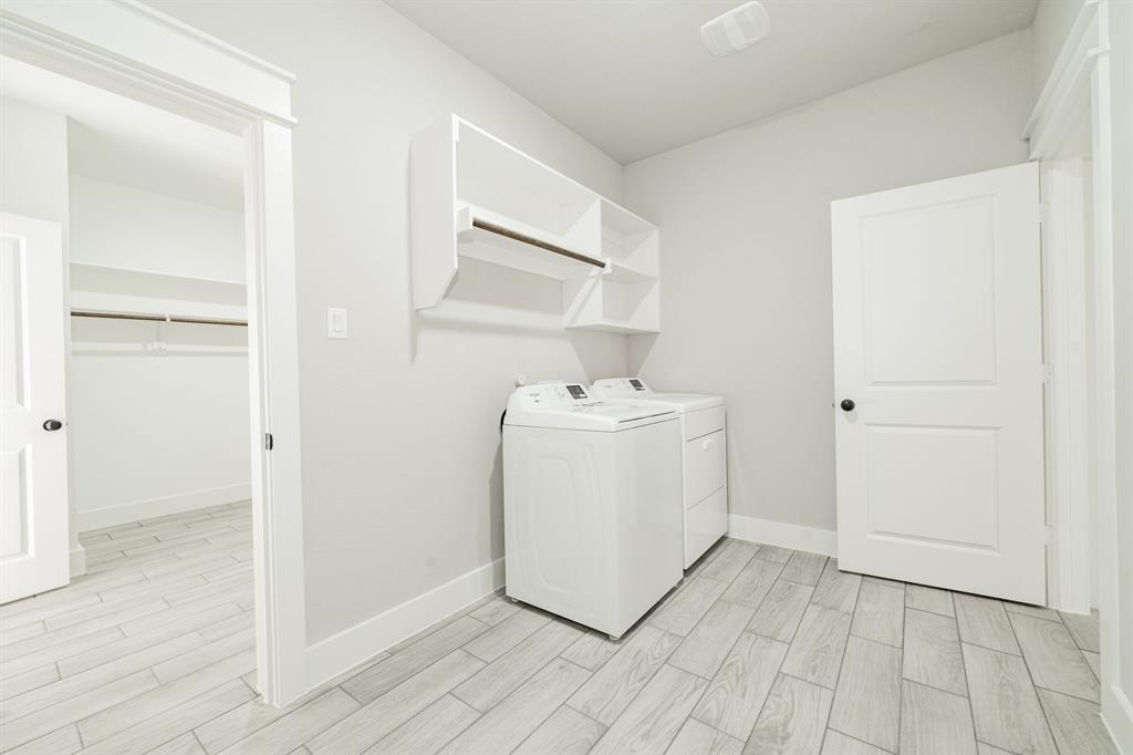 2017 Swallowtail Court Poolville, TX 76487 - Photo 18 of 32 a utility room with cabinets washer and dryer