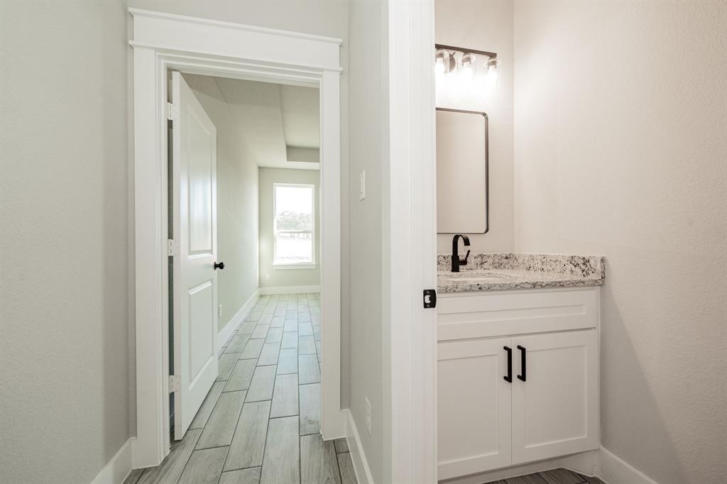 2017 Swallowtail Court Poolville, TX 76487 - Photo 19 of 32 a bathroom with a sink and a mirror