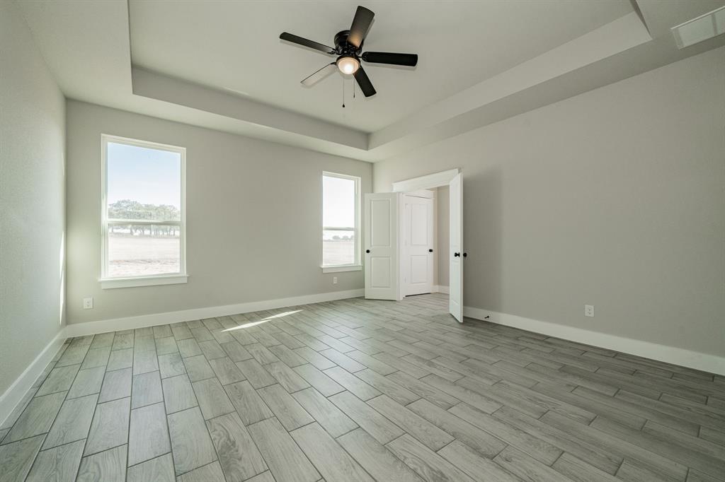 2017 Swallowtail Court Poolville, TX 76487 - Photo 20 of 32 wooden floor in an empty room with a window