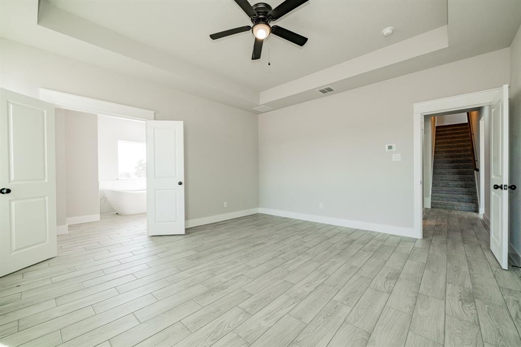 2017 Swallowtail Court Poolville, TX 76487 - Photo 21 of 32 an empty room with wooden floor and ceiling fan