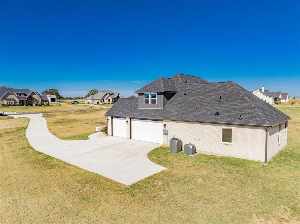 2017 Swallowtail Court Poolville, TX 76487 - Photo 3 of 32 a view of a house with a yard