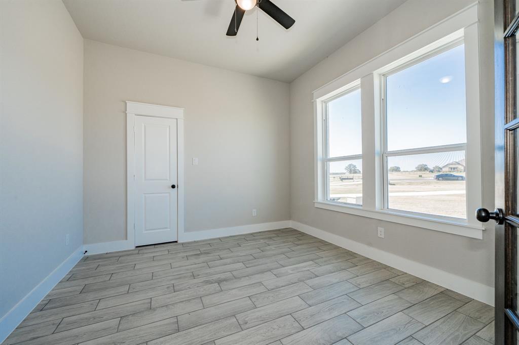 2017 Swallowtail Court Poolville, TX 76487 - Photo 9 of 32 wooden floor in an empty room with a window