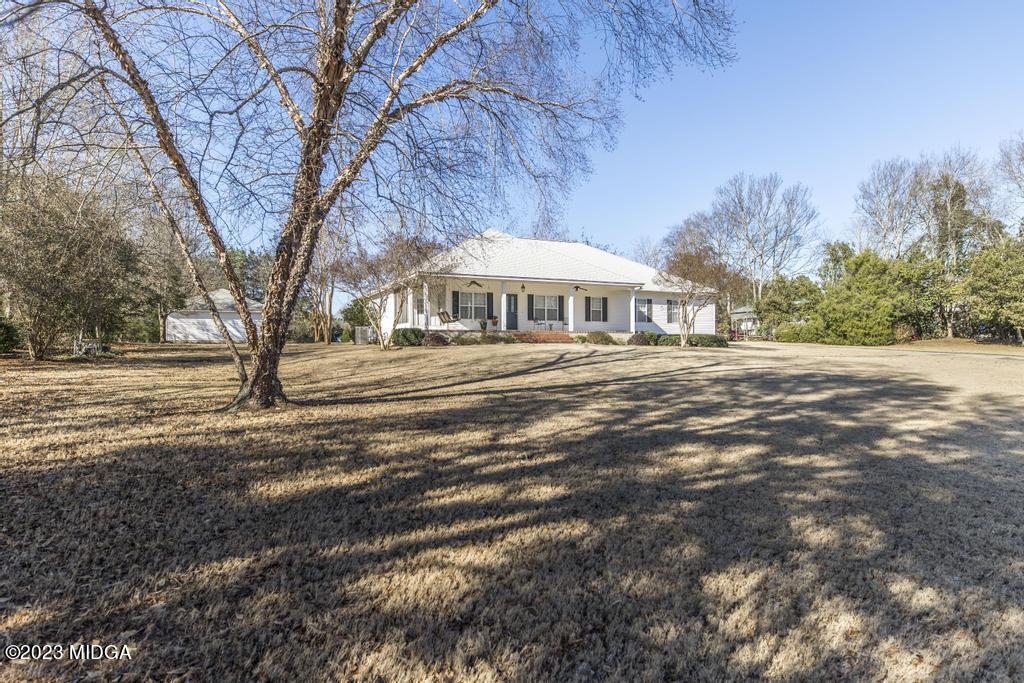 6375 Barfield Road Macon, GA 31216 - Photo 1 of 60 a front view of a house with a yard and trees
