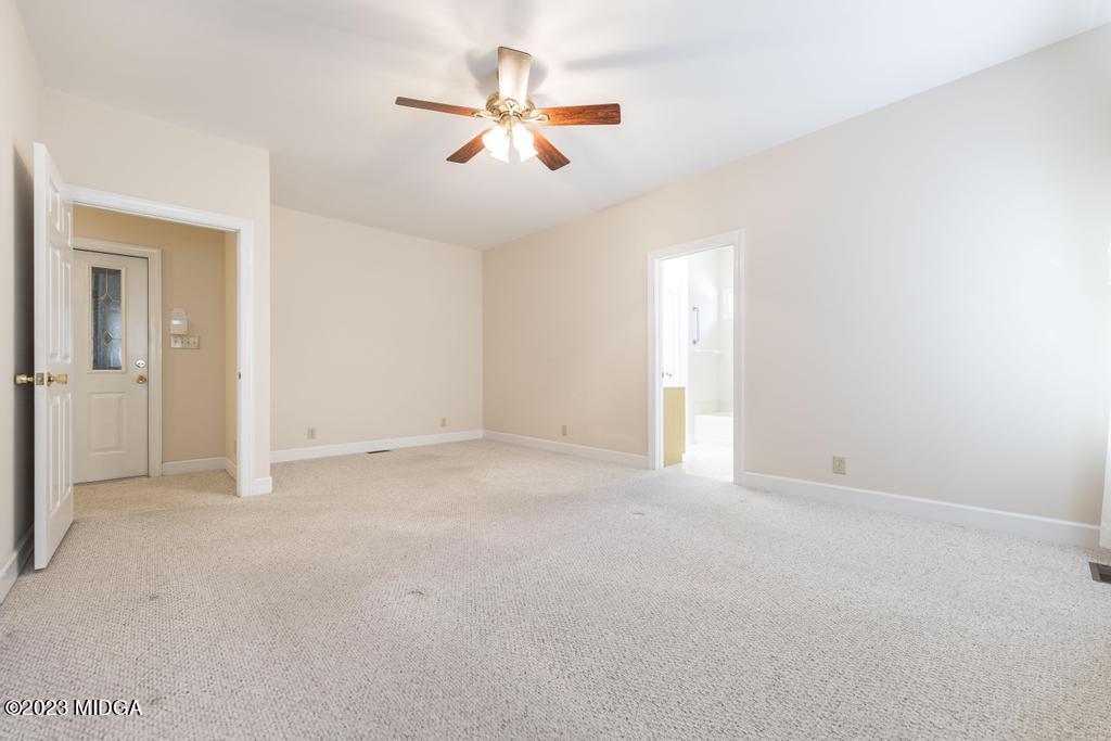 6375 Barfield Road Macon, GA 31216 - Photo 23 of 60 an empty room with ceiling fan and window