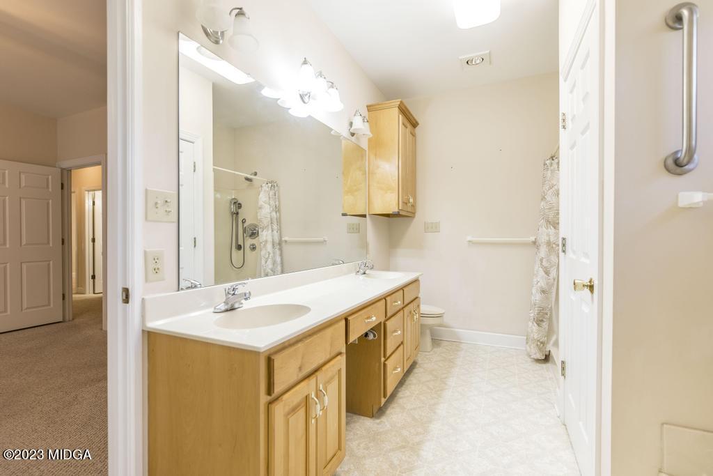 6375 Barfield Road Macon, GA 31216 - Photo 26 of 60 a bathroom with a sink and a mirror