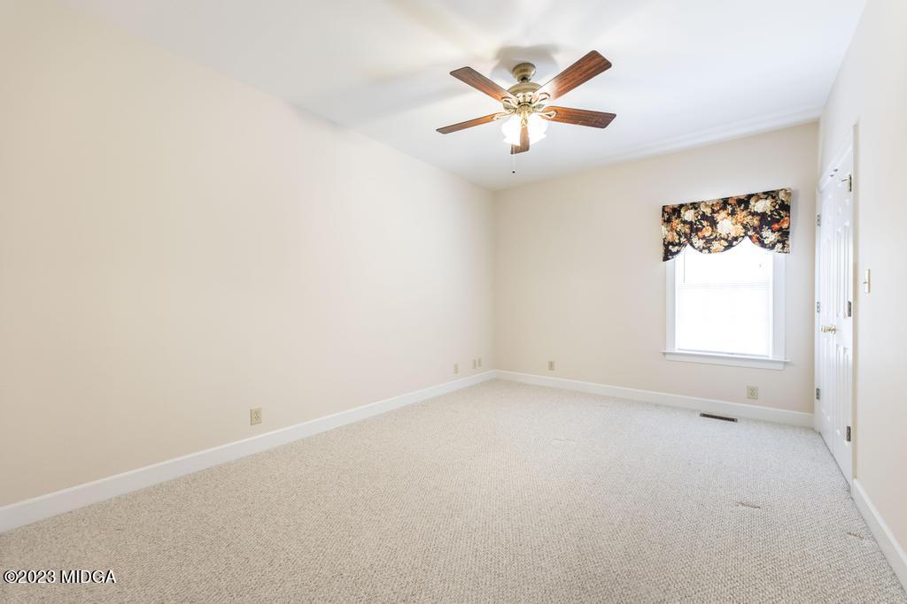 6375 Barfield Road Macon, GA 31216 - Photo 34 of 60 an empty room with a window and ceiling fan