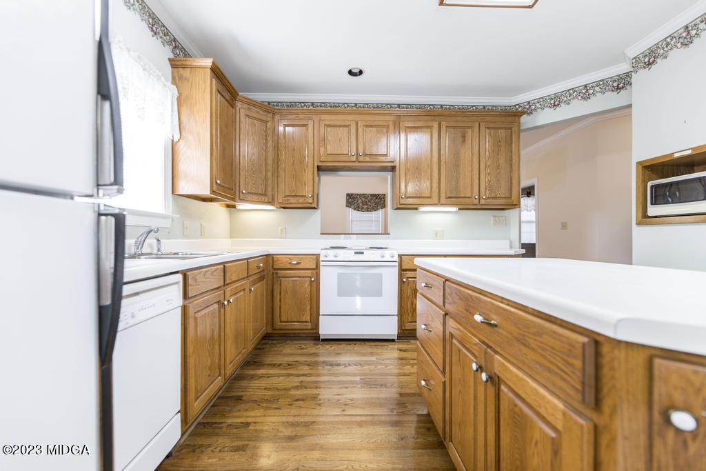 6375 Barfield Road Macon, GA 31216 - Photo 42 of 60 a kitchen with stainless steel appliances granite countertop a sink stove and refrigerator
