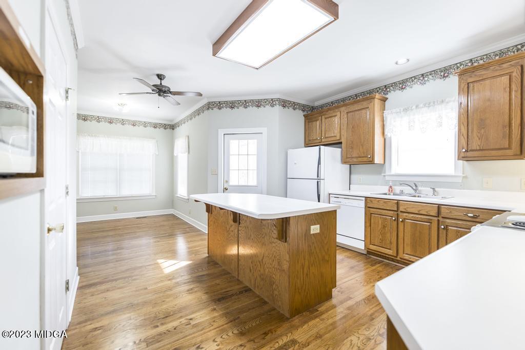 6375 Barfield Road Macon, GA 31216 - Photo 46 of 60 a kitchen with stainless steel appliances granite countertop a sink a stove and wooden floors