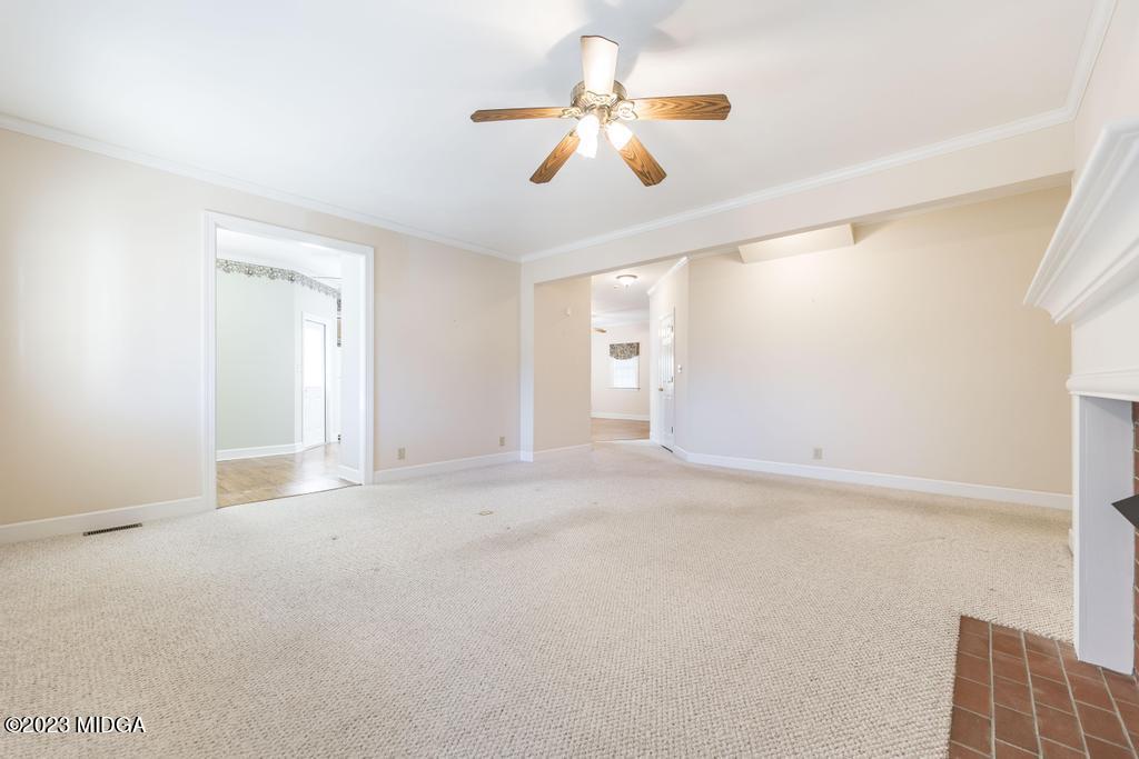 6375 Barfield Road Macon, GA 31216 - Photo 53 of 60 an empty room with chandelier fan and windows