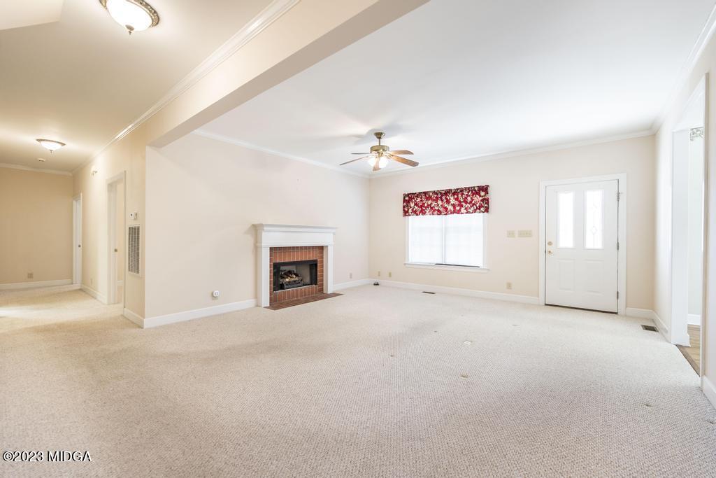 6375 Barfield Road Macon, GA 31216 - Photo 55 of 60 an empty room with windows and fireplace