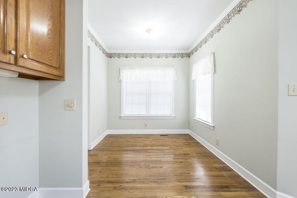 6375 Barfield Road Macon, GA 31216 - Photo 57 of 60 a view of an empty room with wooden floor and a window