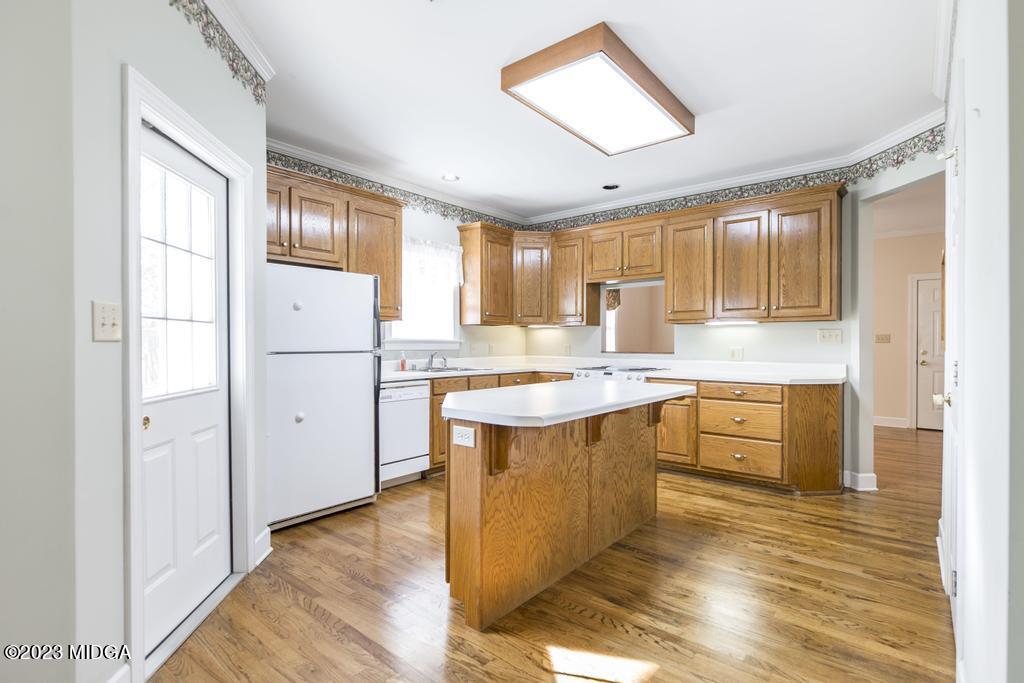 6375 Barfield Road Macon, GA 31216 - Photo 59 of 60 a kitchen with refrigerator cabinets and wooden floor
