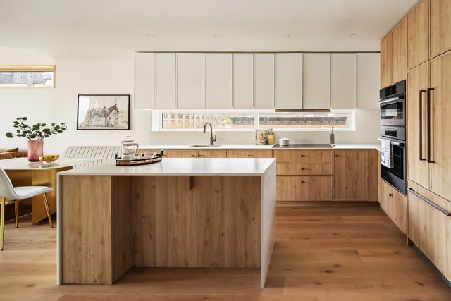 a kitchen with stainless steel appliances a sink cabinets and wooden floor