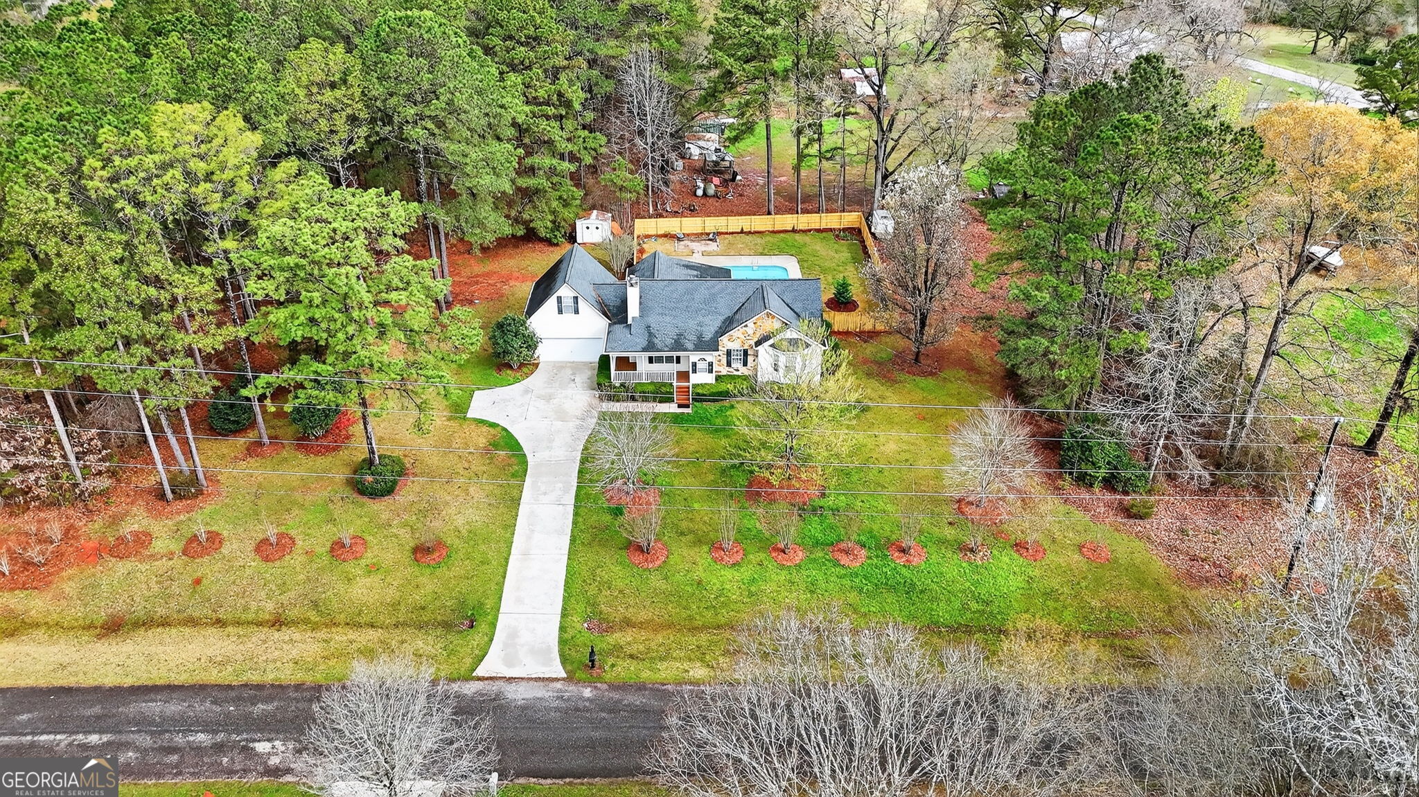 an aerial view of a house with a yard basket ball court