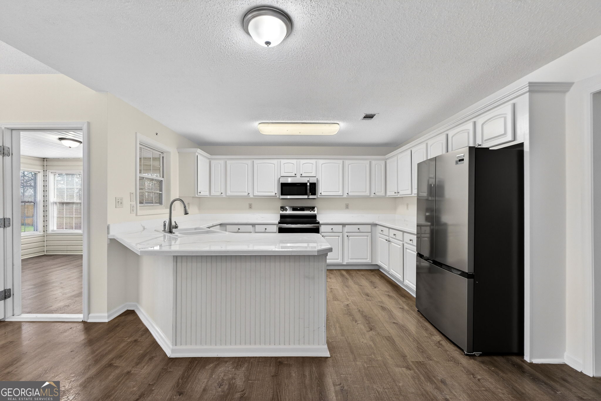108 Whippoorwill Ridge Road Jackson, GA 30233 - Photo 12 of 39 a kitchen with a refrigerator a sink and a stove top oven