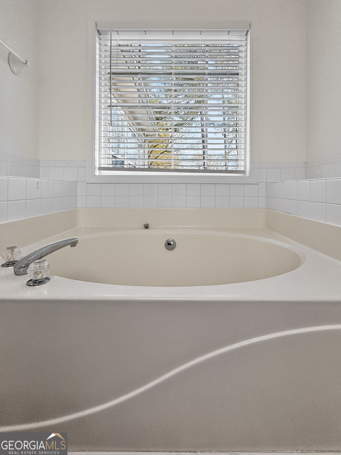 108 Whippoorwill Ridge Road Jackson, GA 30233 - Photo 23 of 39 a white bath tub sitting next to a window