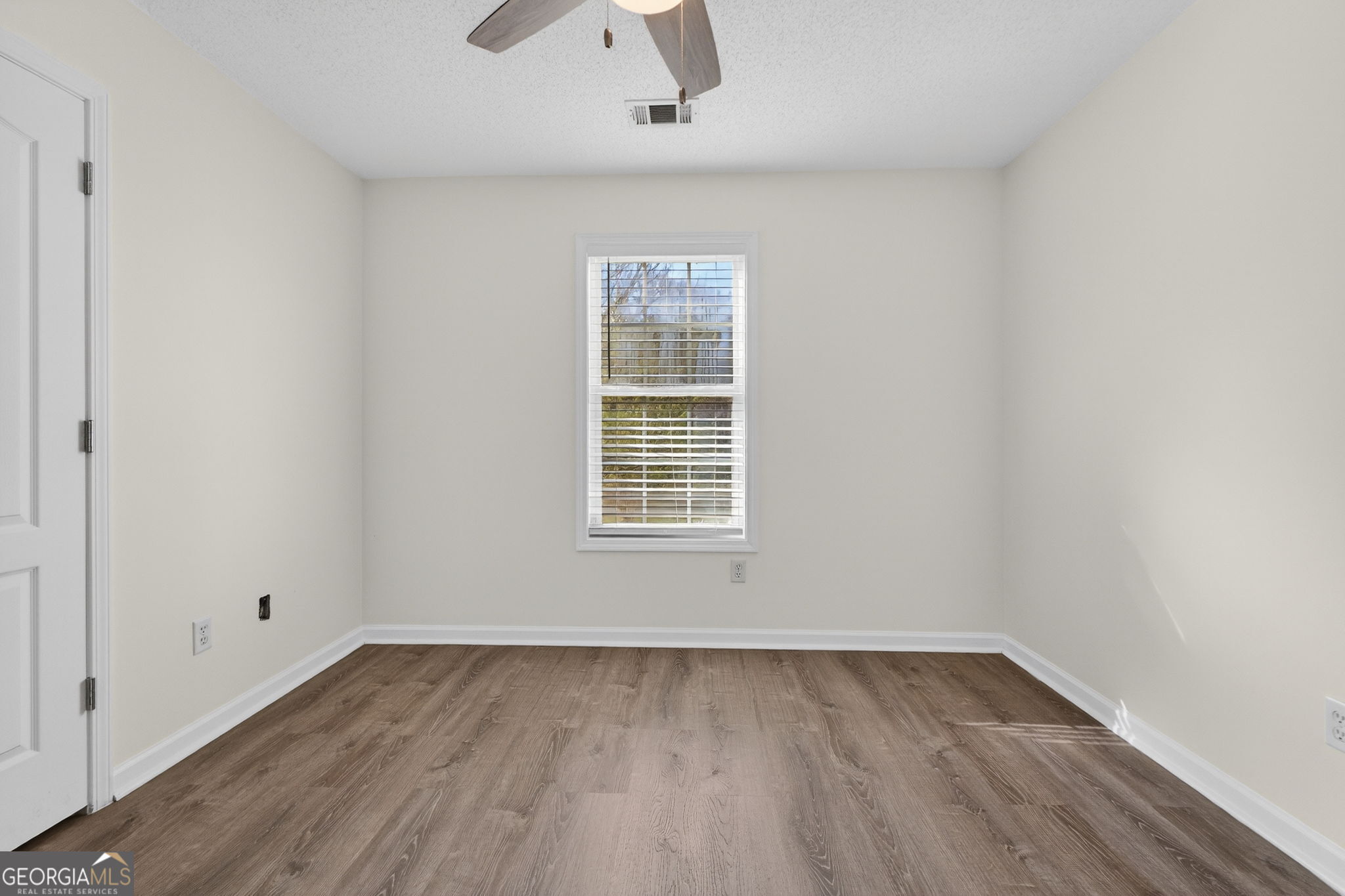 108 Whippoorwill Ridge Road Jackson, GA 30233 - Photo 30 of 39 an empty room with wooden floor and windows