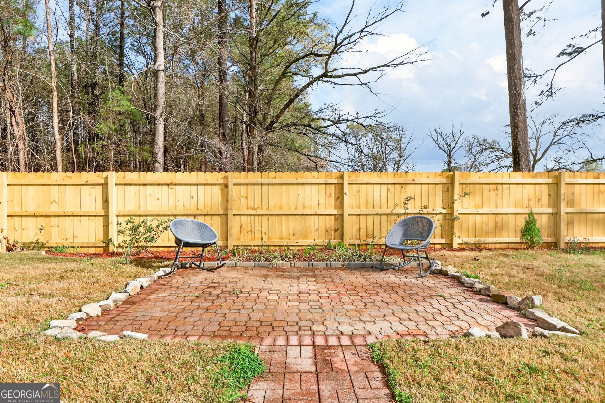 108 Whippoorwill Ridge Road Jackson, GA 30233 - Photo 38 of 39 a backyard of a house with table and chairs