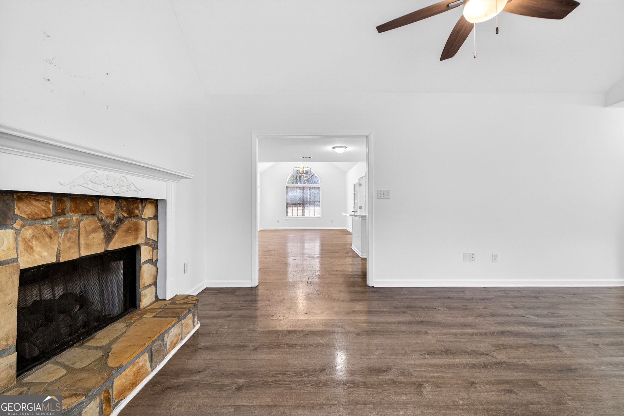 108 Whippoorwill Ridge Road Jackson, GA 30233 - Photo 10 of 39 an empty room with wooden floor fireplace and windows