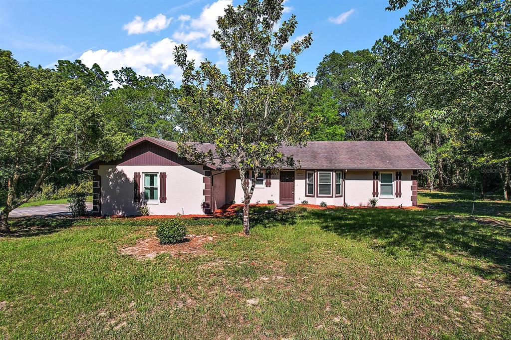 9655 Southwest 200th Court Dunnellon, FL 34431 - Photo 1 of 1 a front view of a house with a garden