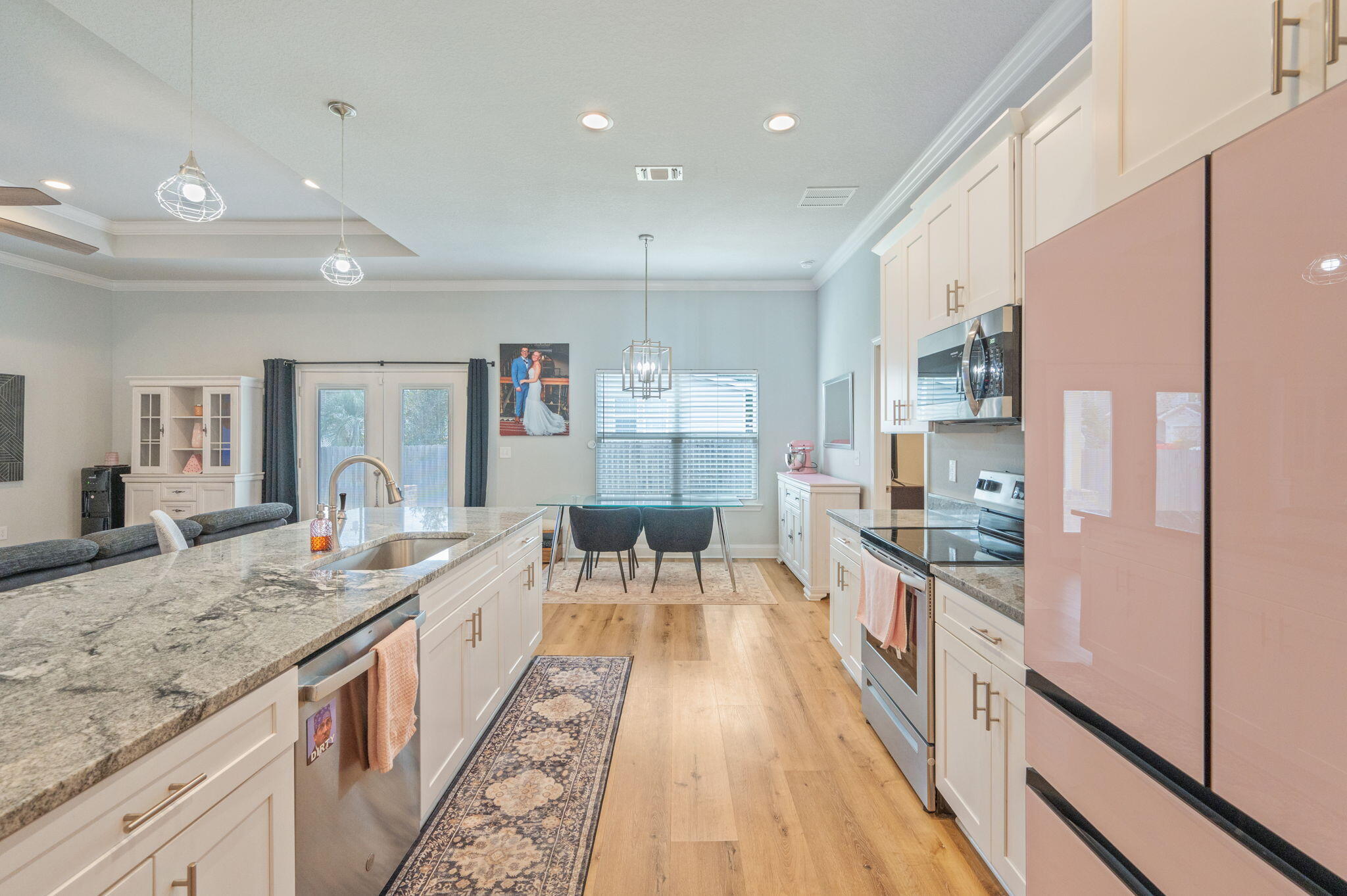 899 Al Hammett Road Mary Esther, FL 32569 - Photo 12 of 34 a large kitchen with kitchen island a large counter space a sink appliances and cabinets