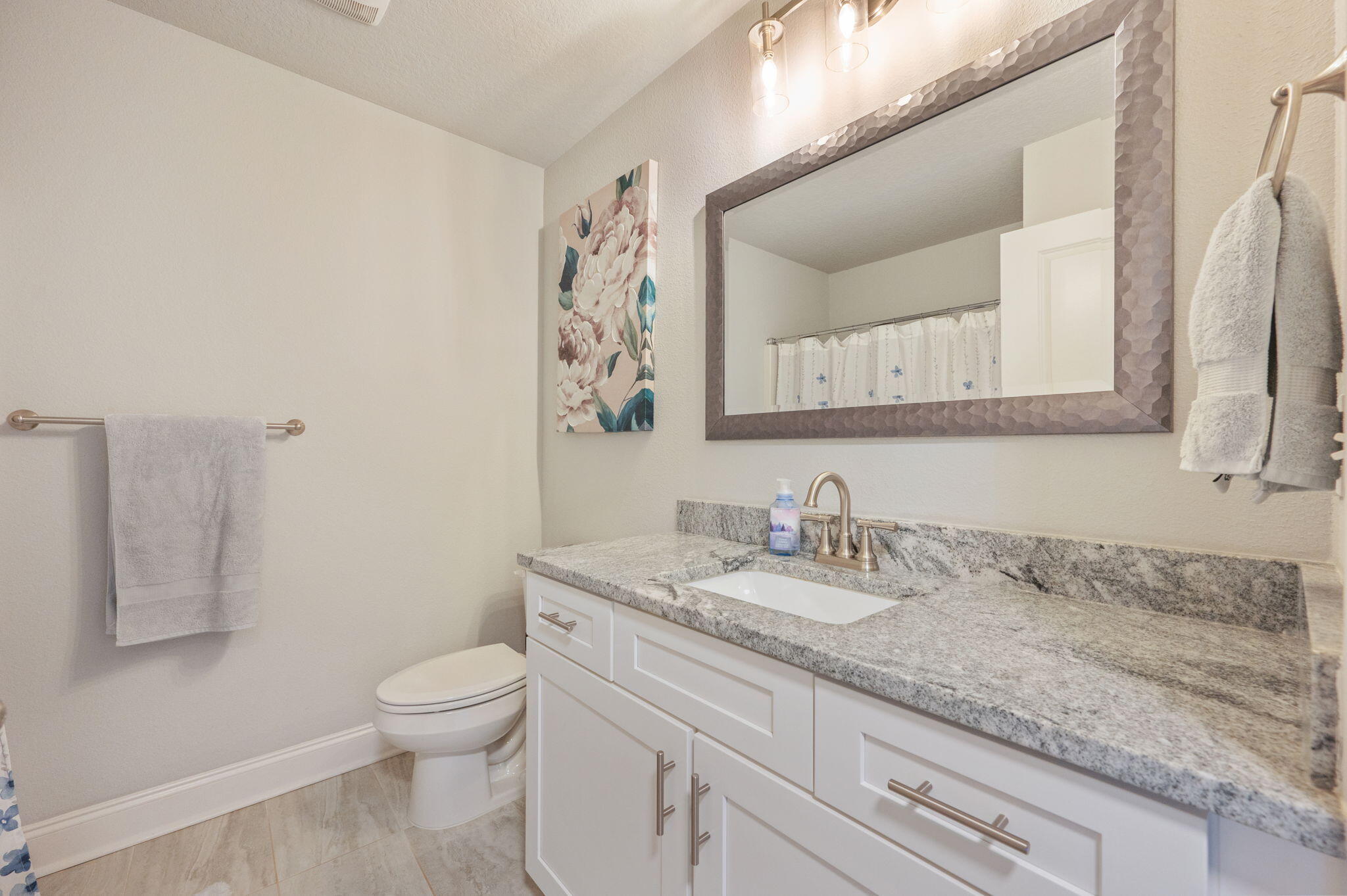 899 Al Hammett Road Mary Esther, FL 32569 - Photo 18 of 34 a bathroom with a granite countertop toilet sink and mirror