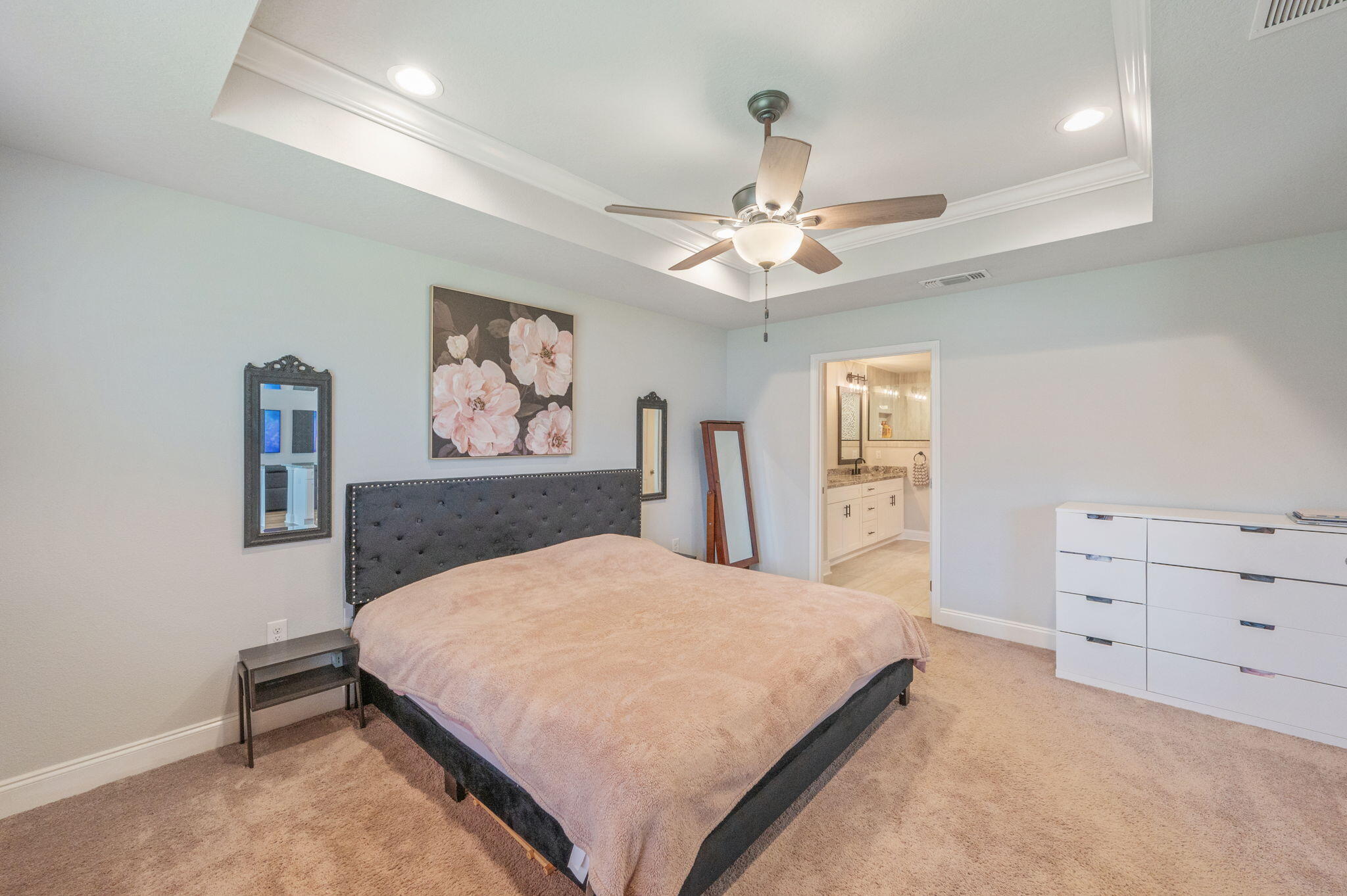 899 Al Hammett Road Mary Esther, FL 32569 - Photo 22 of 34 a bedroom with a large bed and a chandelier