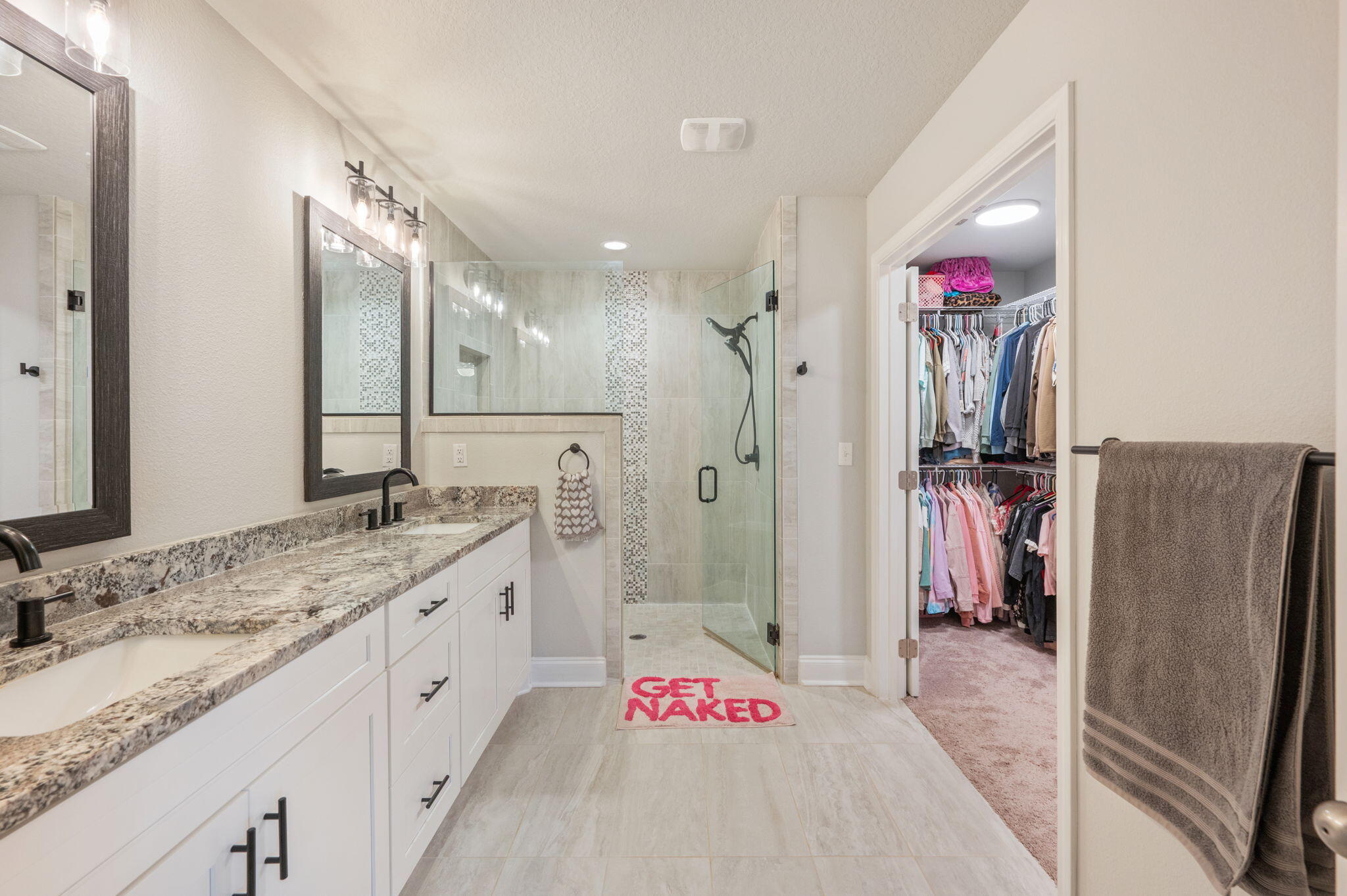 899 Al Hammett Road Mary Esther, FL 32569 - Photo 25 of 34 a spacious bathroom with a granite countertop sink shower and a mirror
