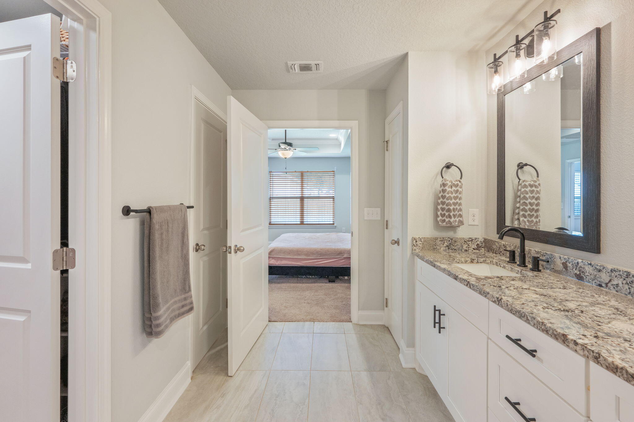 899 Al Hammett Road Mary Esther, FL 32569 - Photo 27 of 34 a bathroom with a granite countertop sink two mirror and a shower