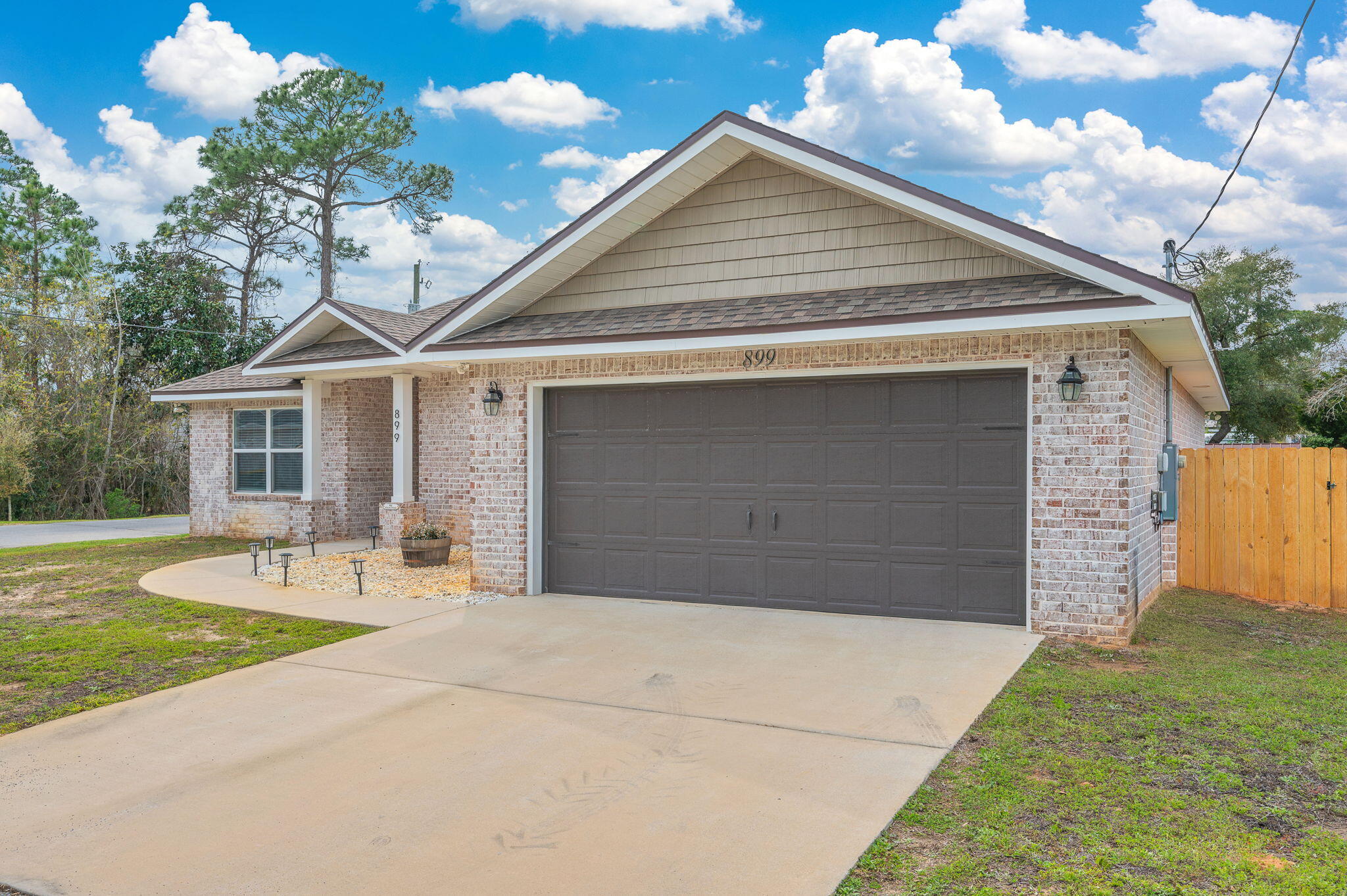 899 Al Hammett Road Mary Esther, FL 32569 - Photo 4 of 34 a front view of a house with garden