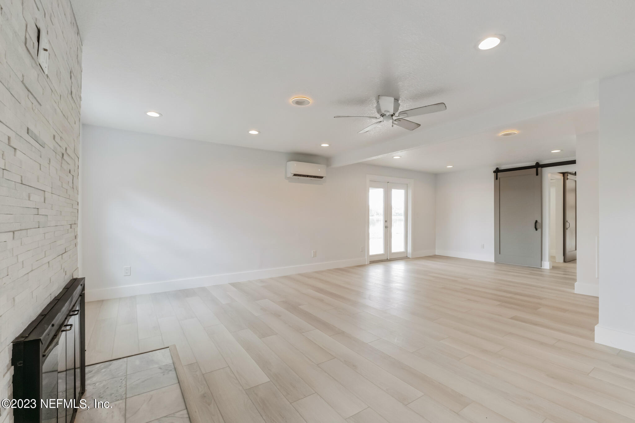 3307 Trout River Boulevard Jacksonville, FL 32208 - Photo 11 of 37 an empty room with wooden floor and windows