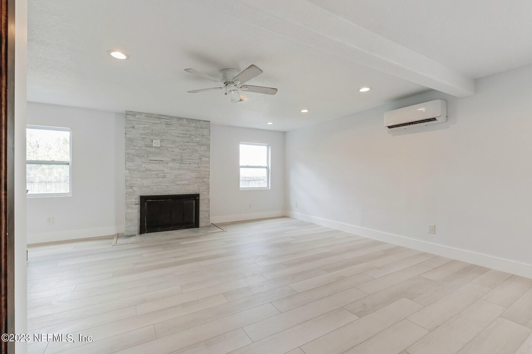 3307 Trout River Boulevard Jacksonville, FL 32208 - Photo 13 of 37 an empty room with windows and fireplace