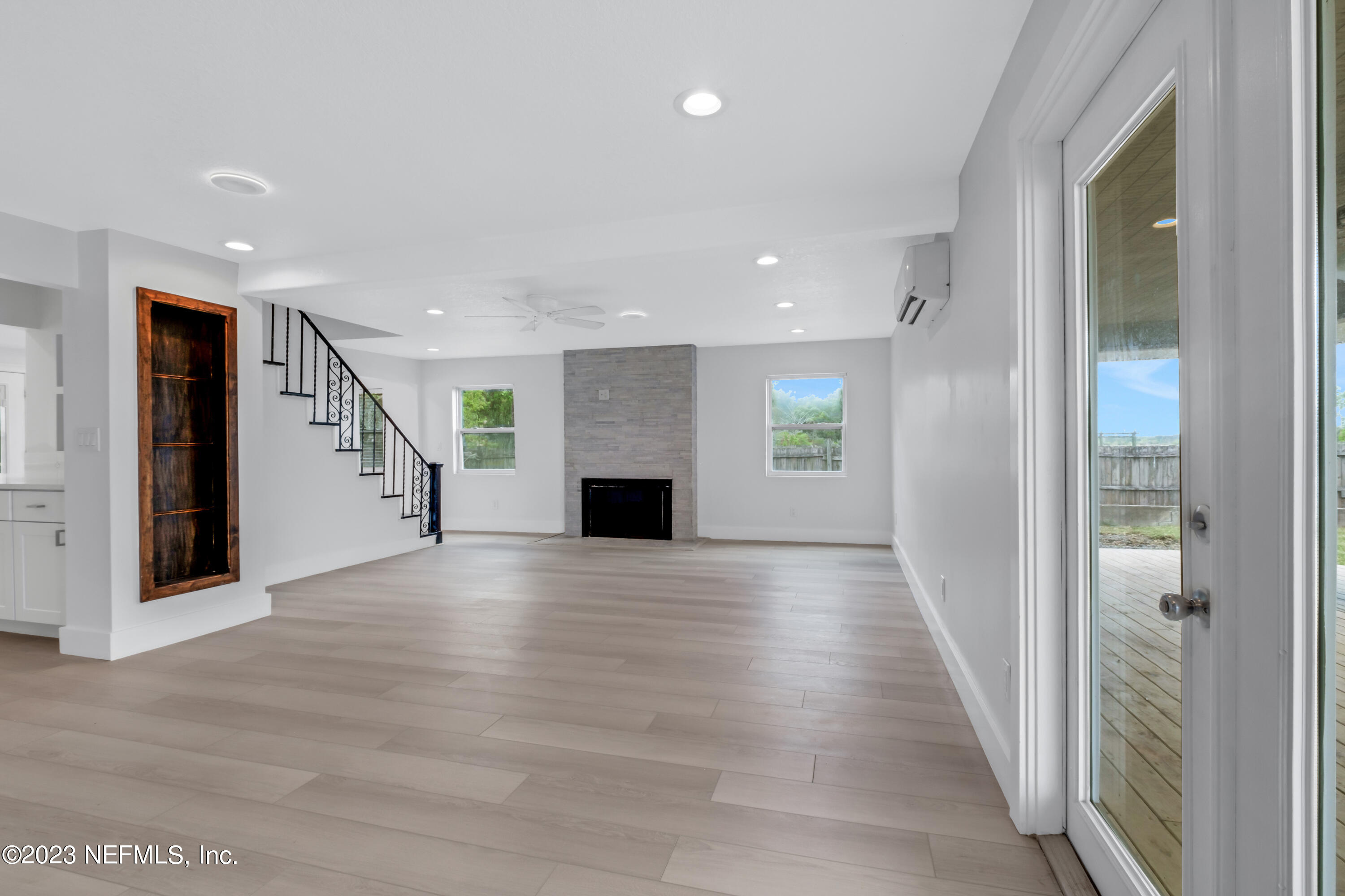 3307 Trout River Boulevard Jacksonville, FL 32208 - Photo 14 of 37 an empty room with wooden floor and windows