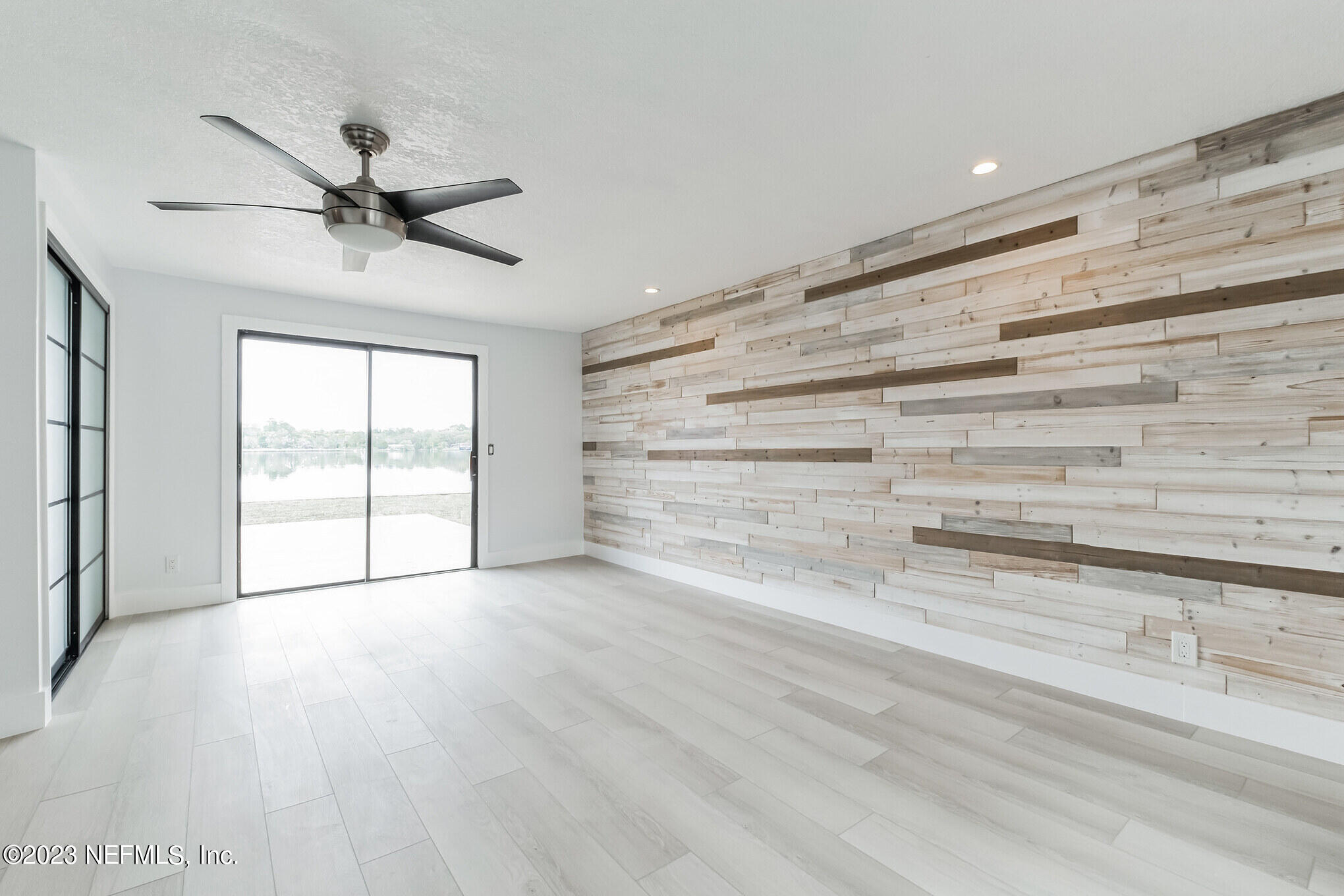 3307 Trout River Boulevard Jacksonville, FL 32208 - Photo 19 of 37 en empty room with wooden floor and fan