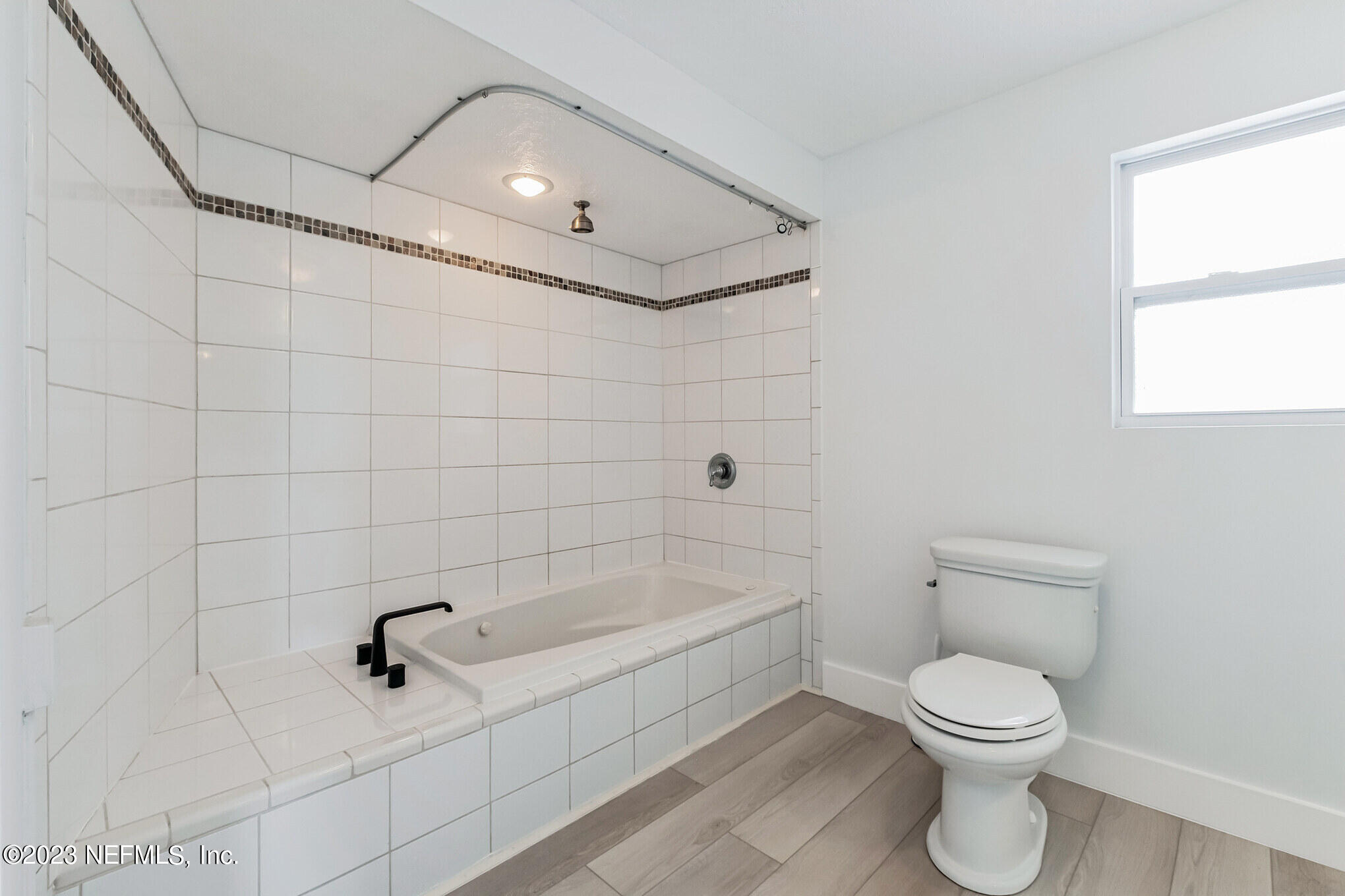 3307 Trout River Boulevard Jacksonville, FL 32208 - Photo 23 of 37 a bathroom with a toilet and a shower