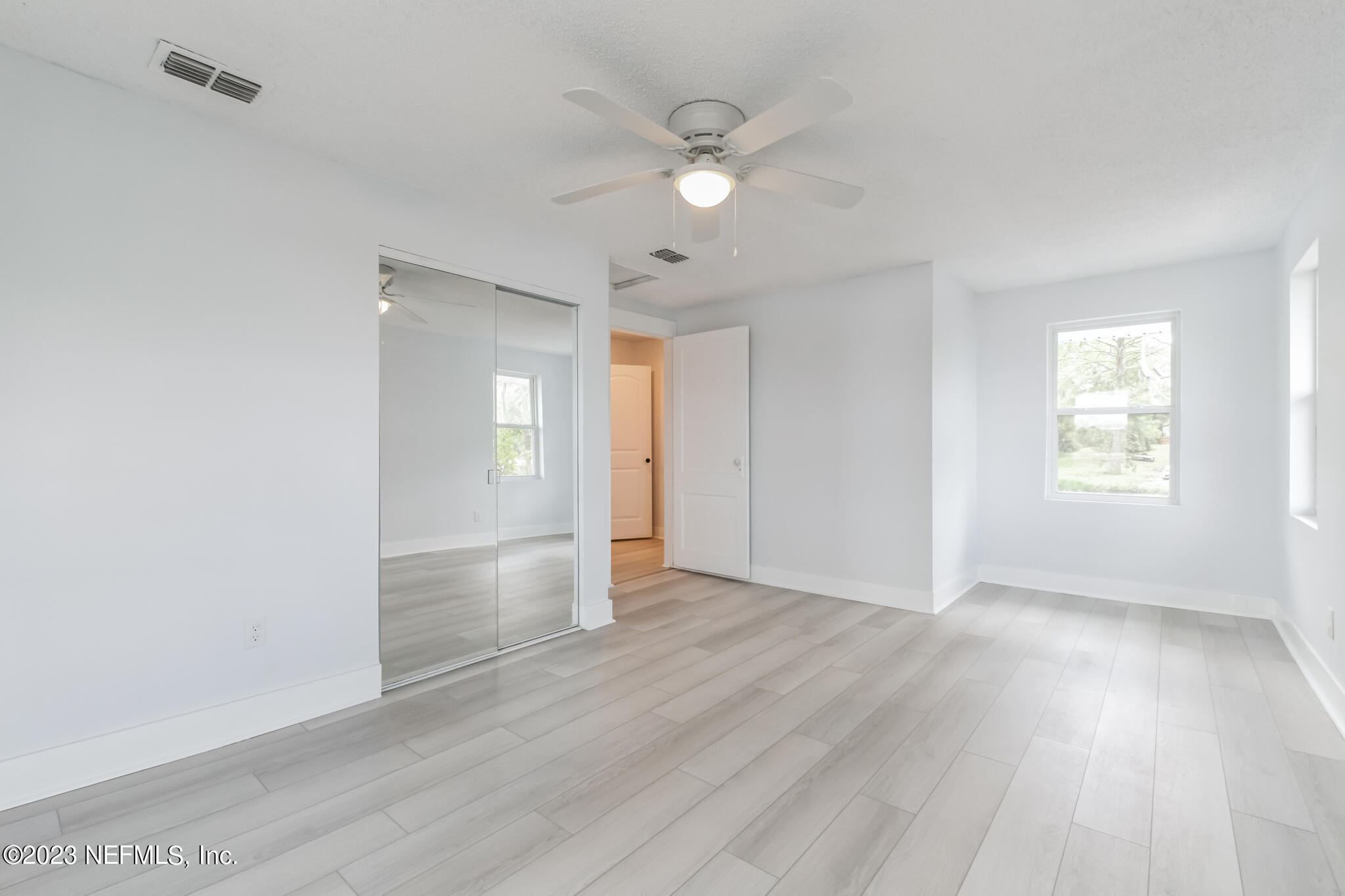 3307 Trout River Boulevard Jacksonville, FL 32208 - Photo 24 of 37 an empty room with wooden floor and windows