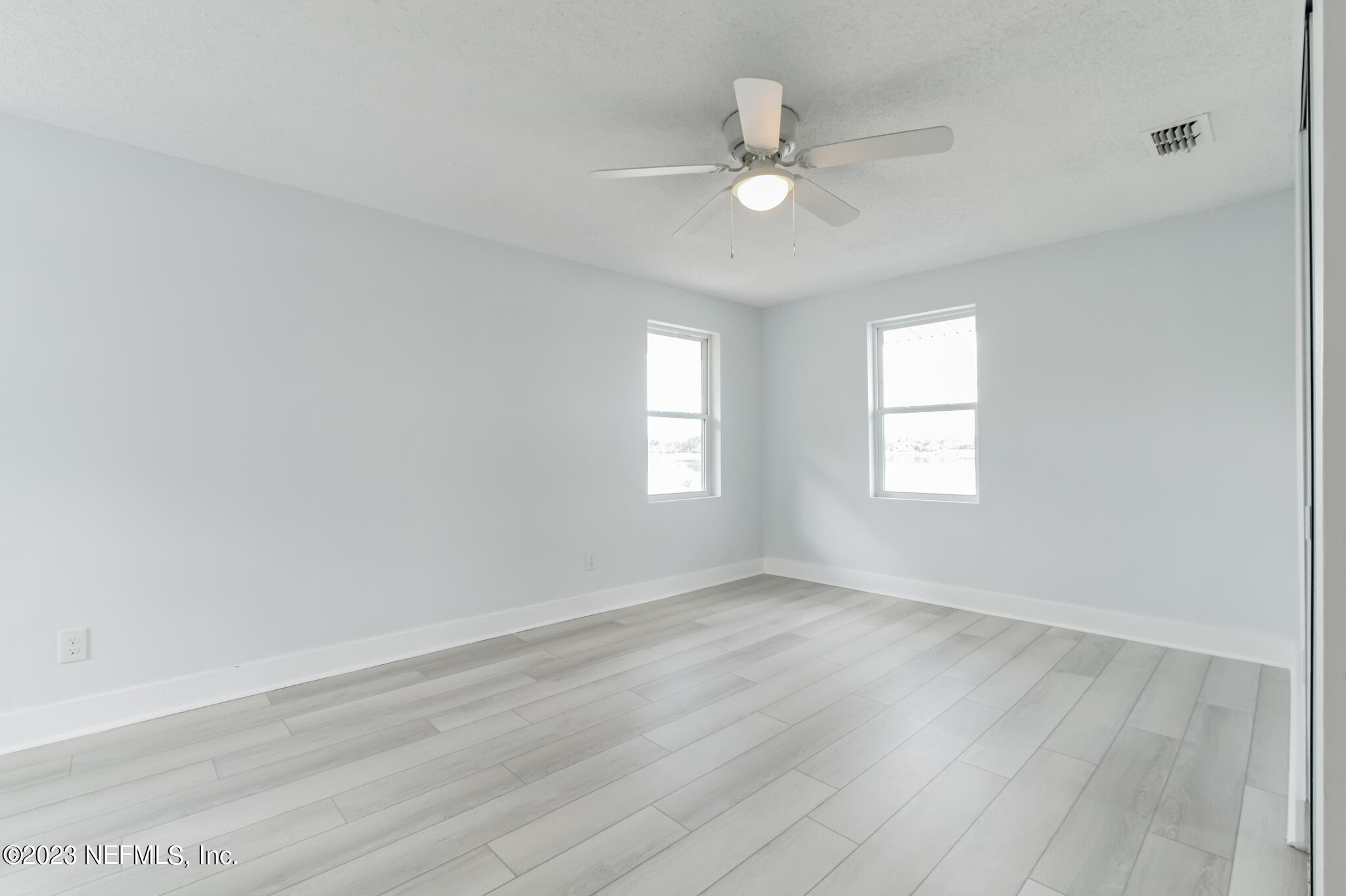 3307 Trout River Boulevard Jacksonville, FL 32208 - Photo 27 of 37 a view of an empty room with wooden floor and a window