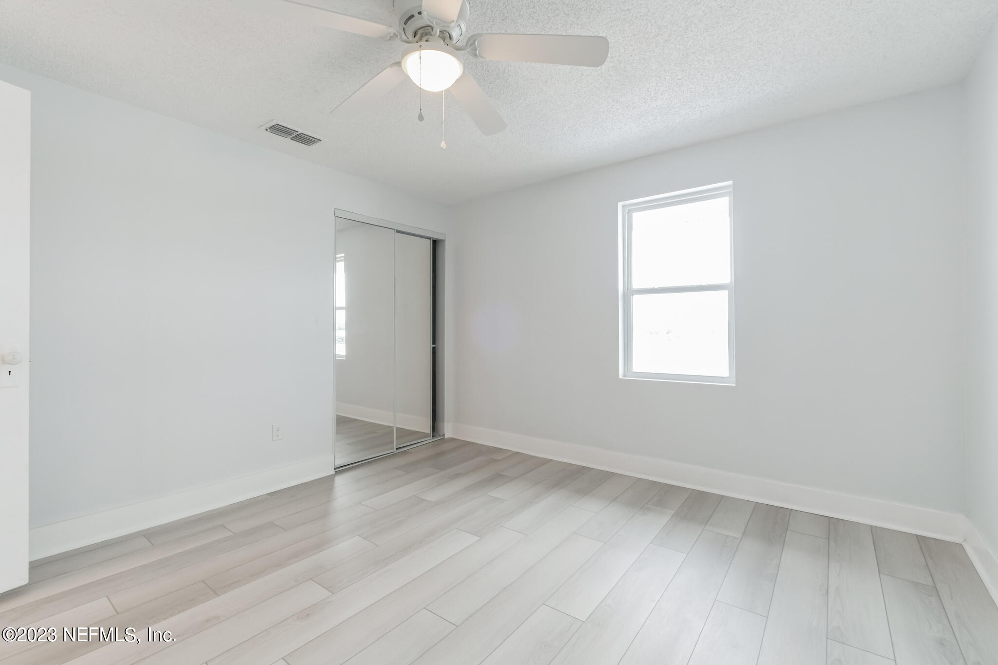 3307 Trout River Boulevard Jacksonville, FL 32208 - Photo 28 of 37 an empty room with wooden floor and windows
