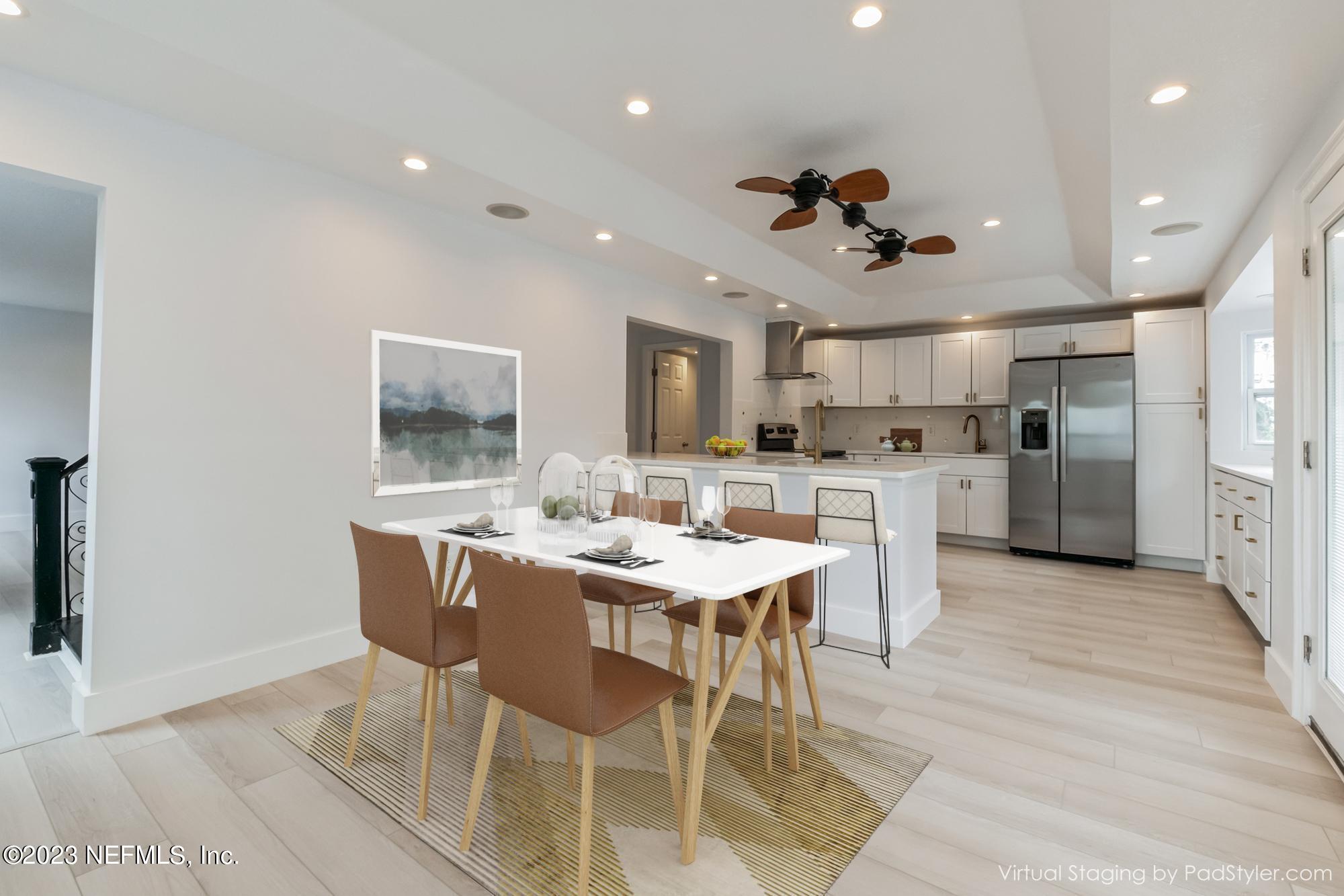 3307 Trout River Boulevard Jacksonville, FL 32208 - Photo 8 of 37 a view of a dining room with furniture and a chandelier