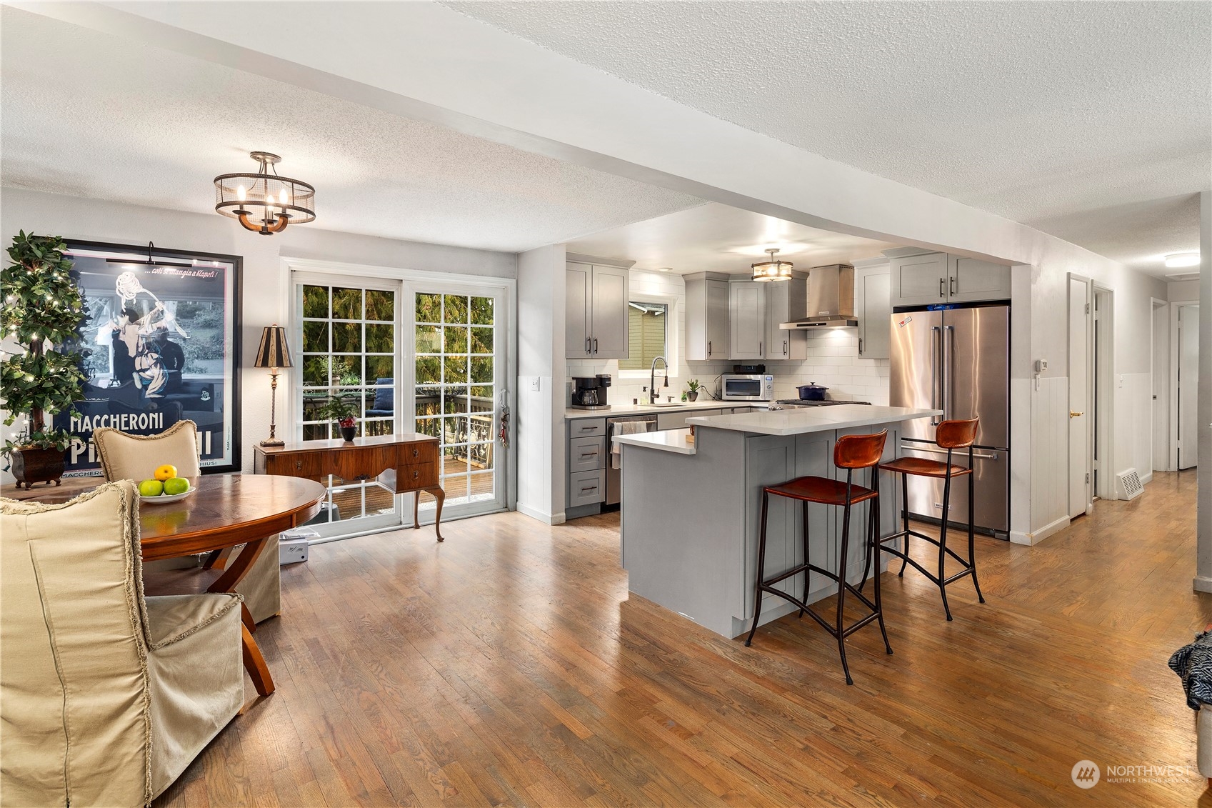 21417 Meridian Drive Southeast Bothell, WA 98021 - Photo 11 of 36 a living room with stainless steel appliances kitchen island granite countertop furniture and a wooden floor