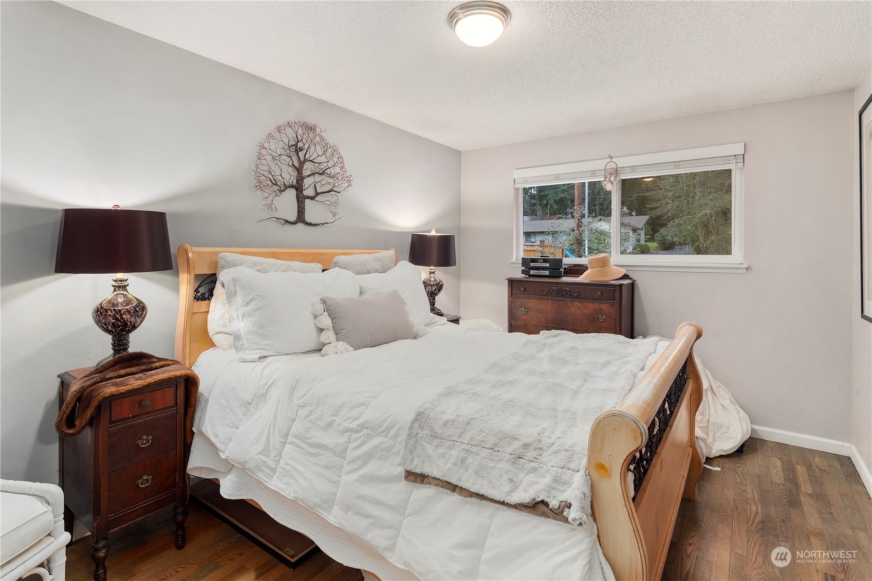 21417 Meridian Drive Southeast Bothell, WA 98021 - Photo 17 of 36 a bedroom with a bed and wooden floor