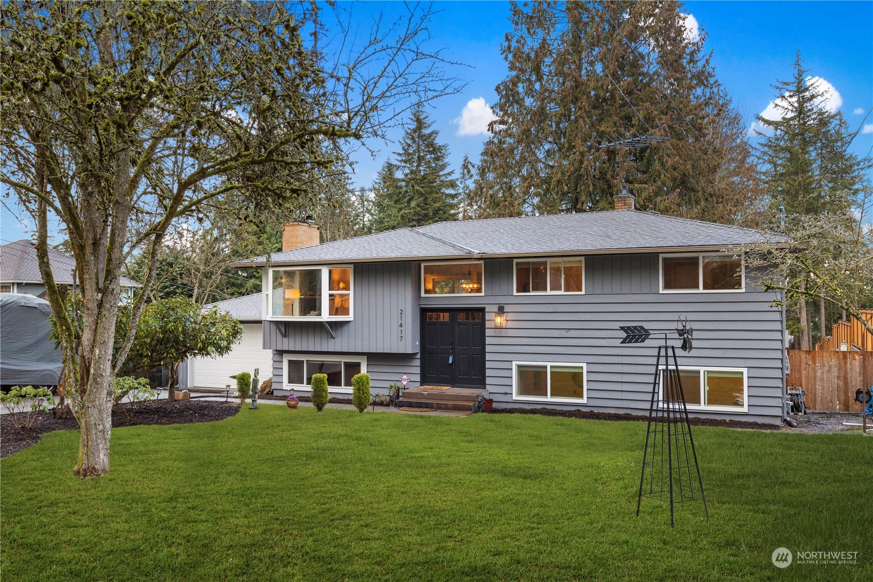 21417 Meridian Drive Southeast Bothell, WA 98021 - Photo 2 of 36 a front view of a house with a garden