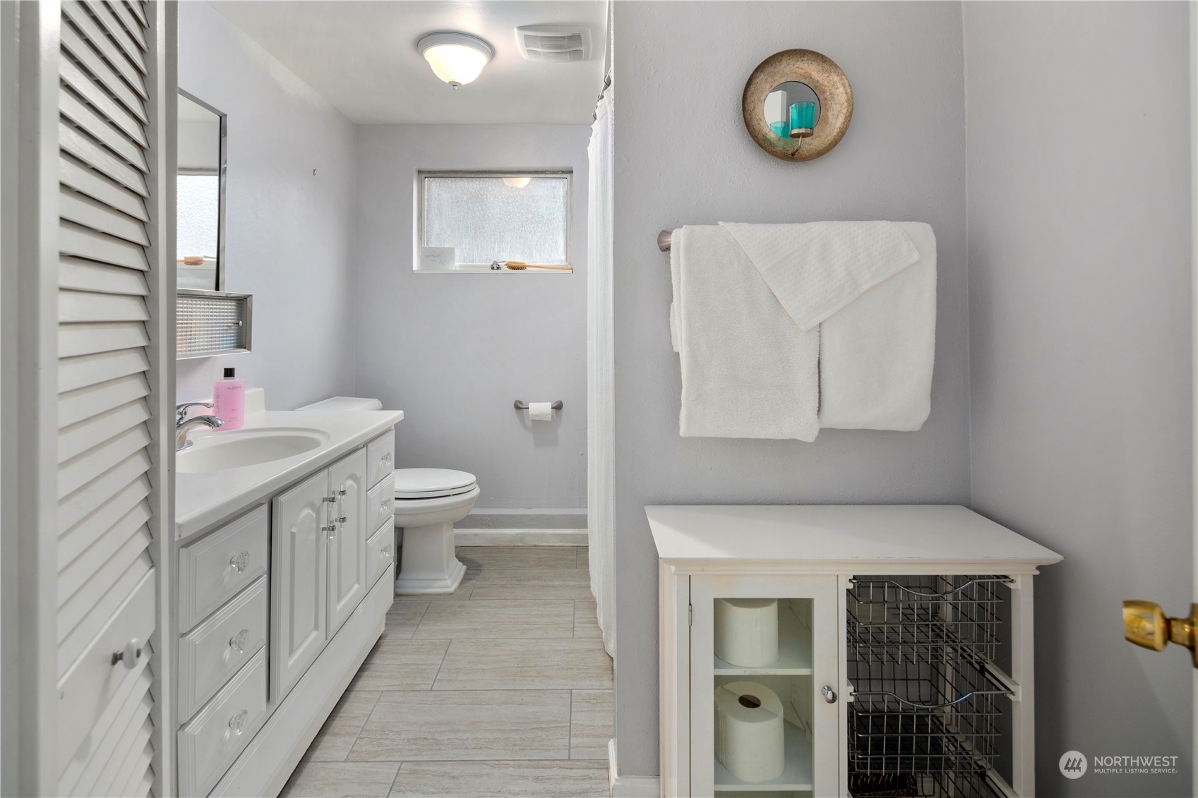 21417 Meridian Drive Southeast Bothell, WA 98021 - Photo 29 of 36 a bathroom with a toilet sink vanity and mirror