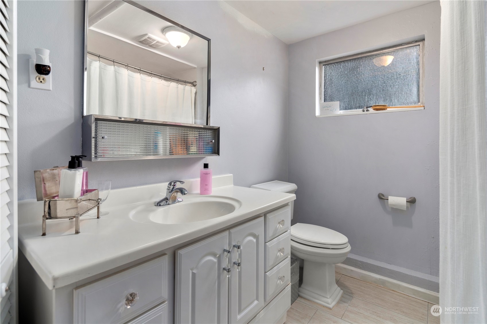 21417 Meridian Drive Southeast Bothell, WA 98021 - Photo 30 of 36 a bathroom with a sink a toilet and mirror